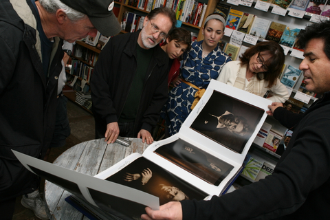 Mark Skelly (far right) shows a four-page insert of 